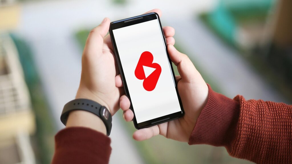 young content creator checking bank account on smartphone