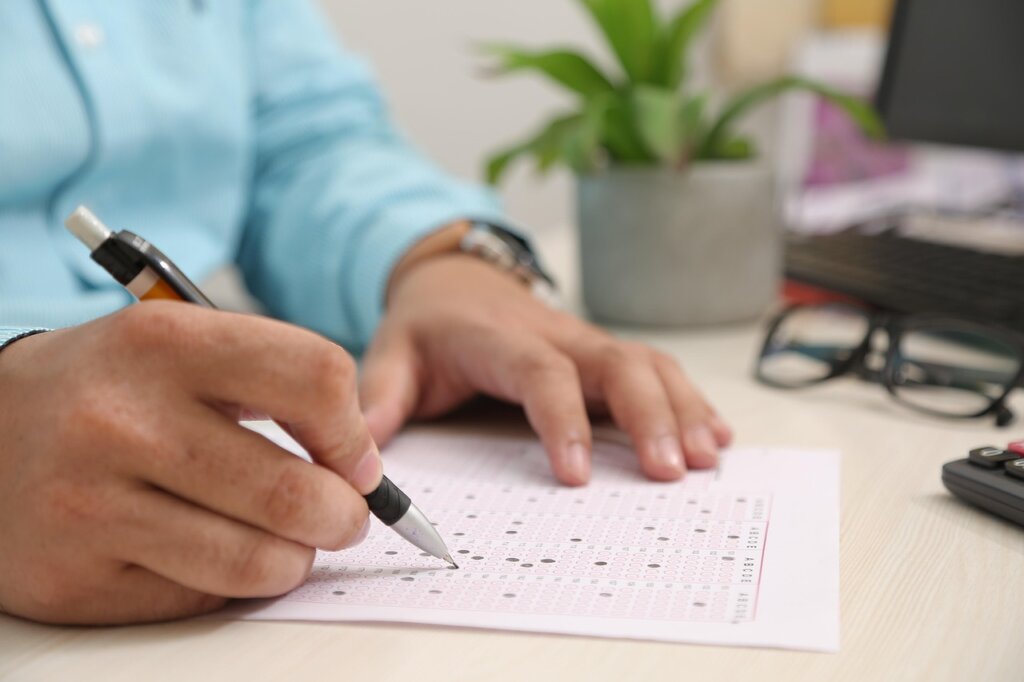 hands filling out application form at community center