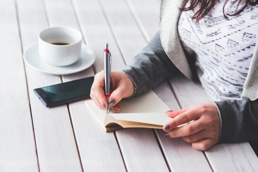 checklist notebook with pen next to a small business registration certificate