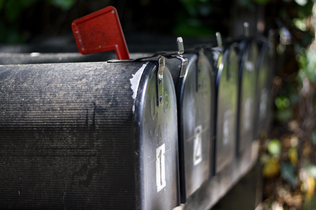 person receiving official notification letter in mailbox