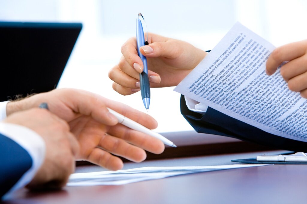 business owner checking documents carefully with pen