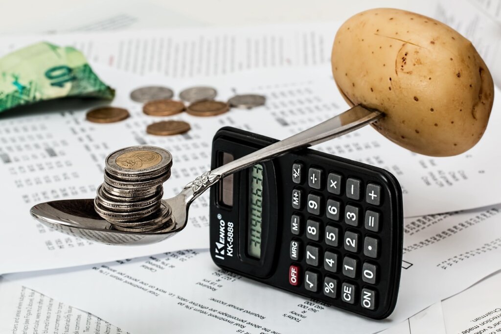 calculator and coins on desk showing cost savings