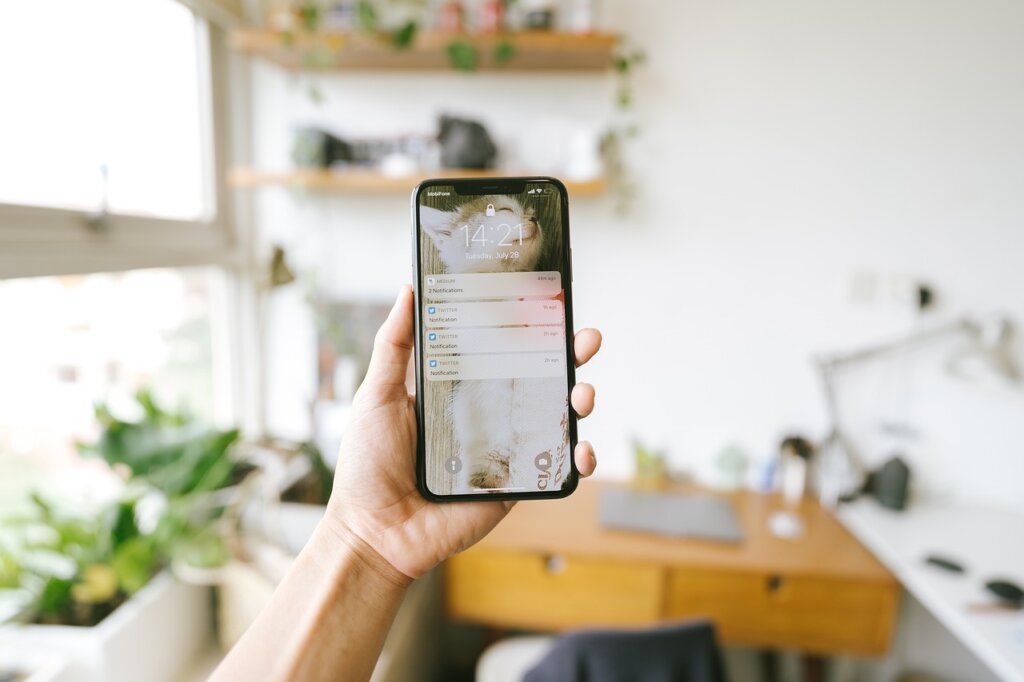 smartphone with welfare app notification alert on screen