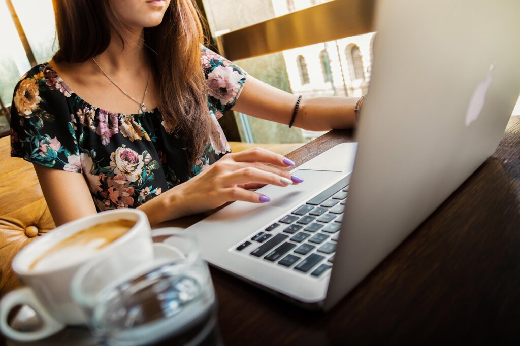 Korean woman looking at government job support website on laptop