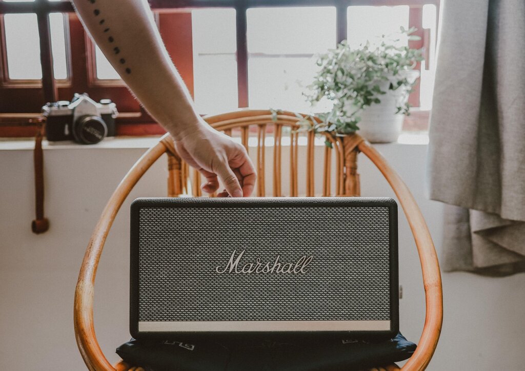 elderly man using AI smart speaker device at home for safety monitoring