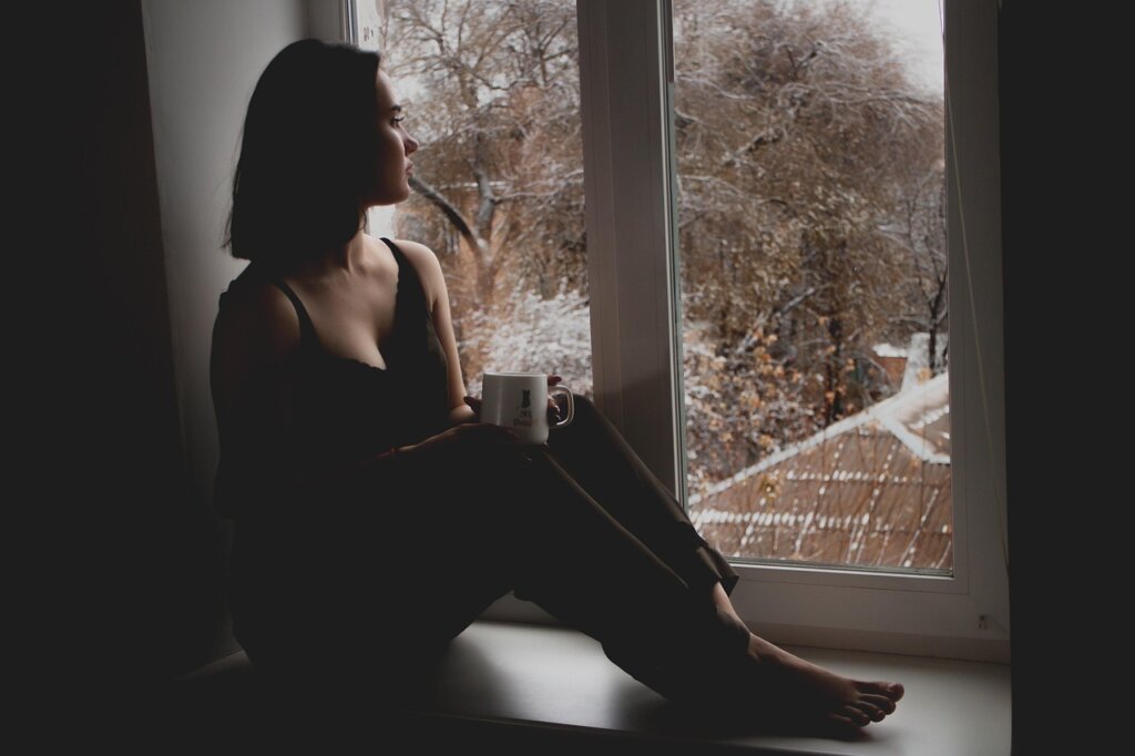 elderly woman living alone in small Korean apartment looking out window