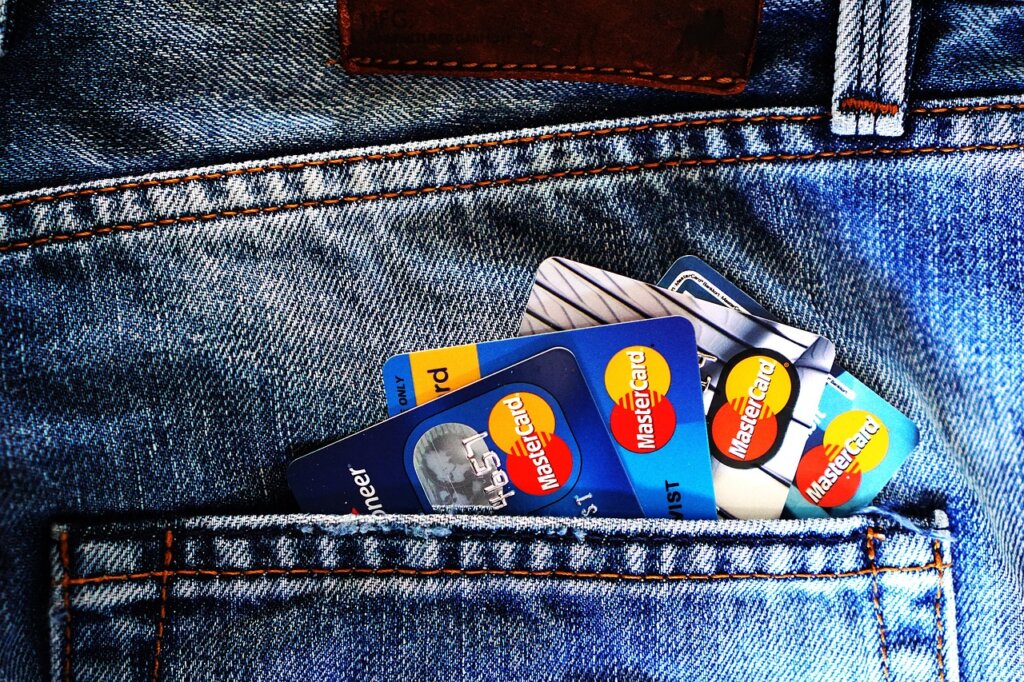 person holding printed work certificate and identification card at bank counter