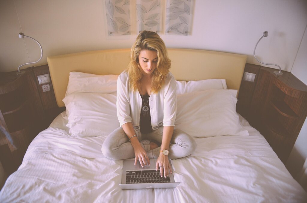 young Korean person checking eligibility requirements on laptop at home