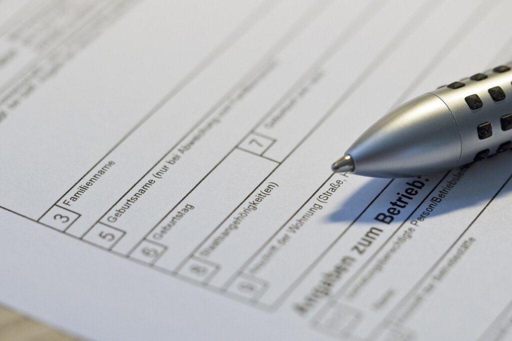 Korean woman filling out loan application form with pen