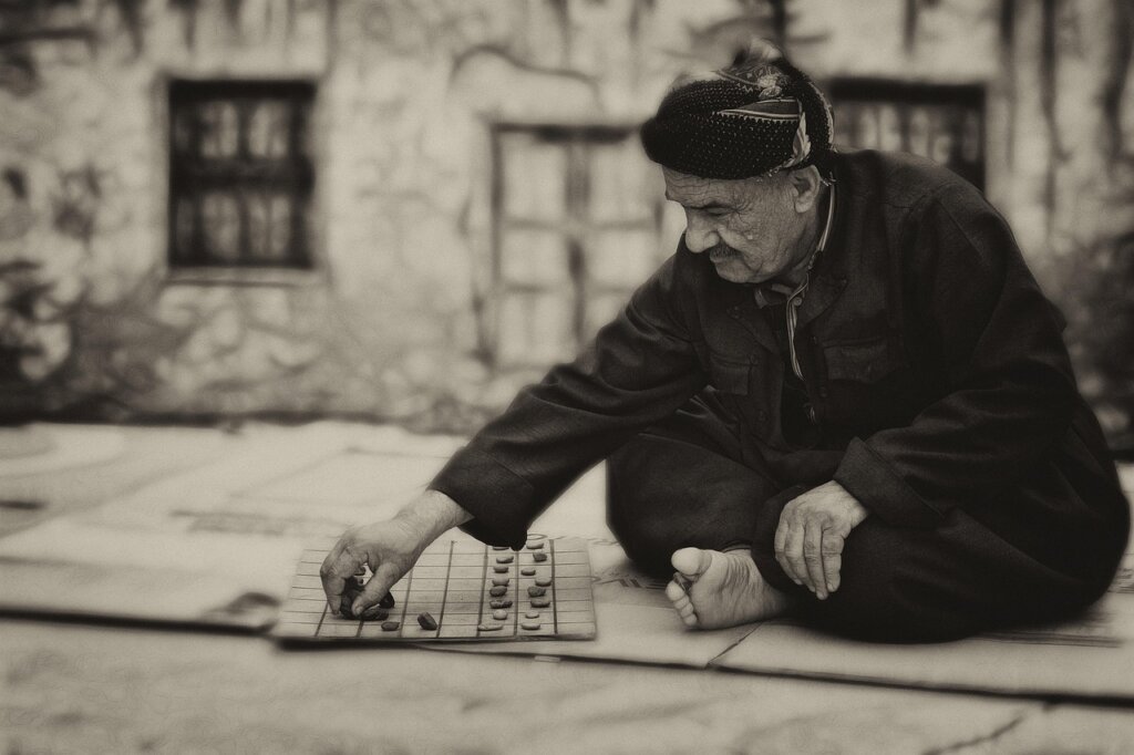 elderly Korean man sitting quietly at a community center window