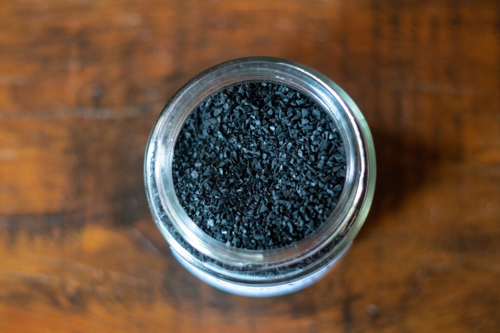 activated charcoal packet beside refrigerator with scientific infographic style
