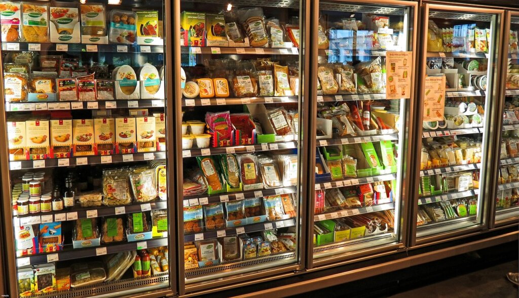 refrigerator interior with various foods and odor sources