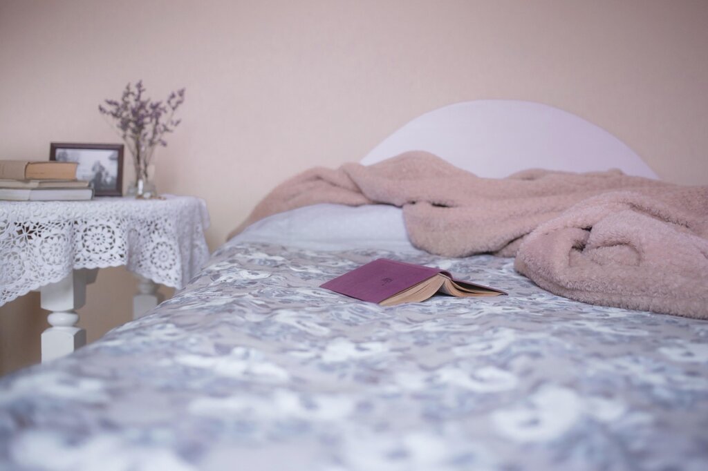 layered bedding setup with electric blanket and memory foam topper
