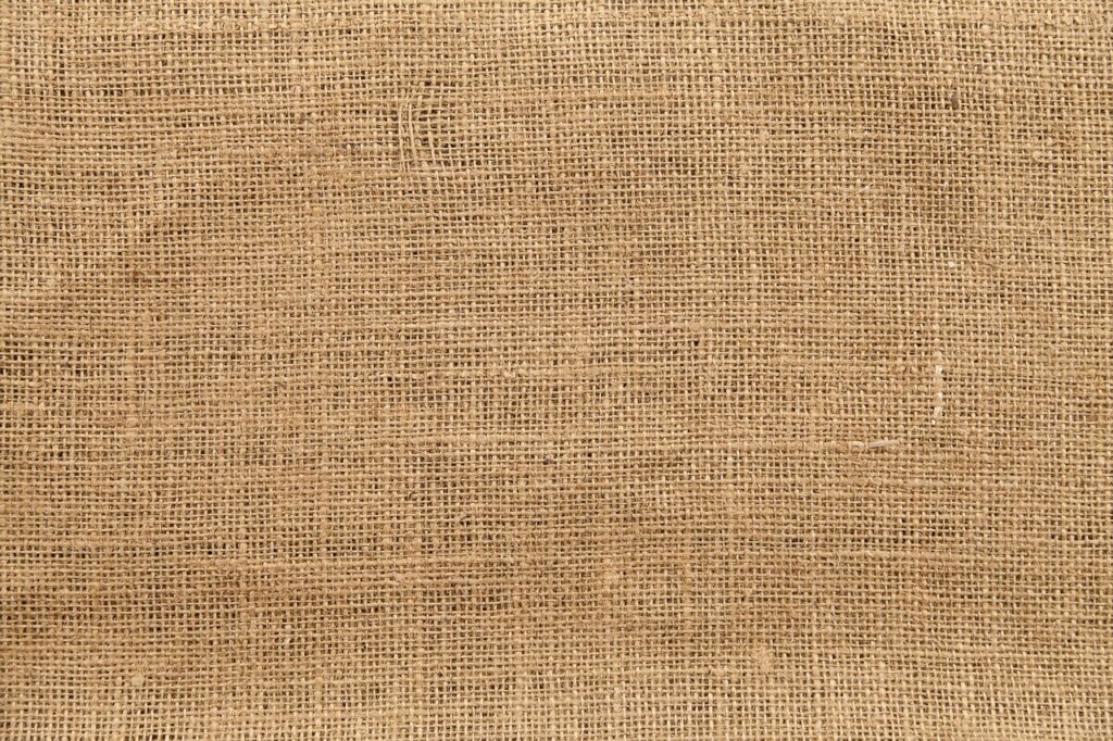 coarse salt in mesh fabric pouch on wooden surface