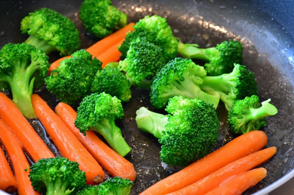 blanched vegetables being packed into freezer bags portioned