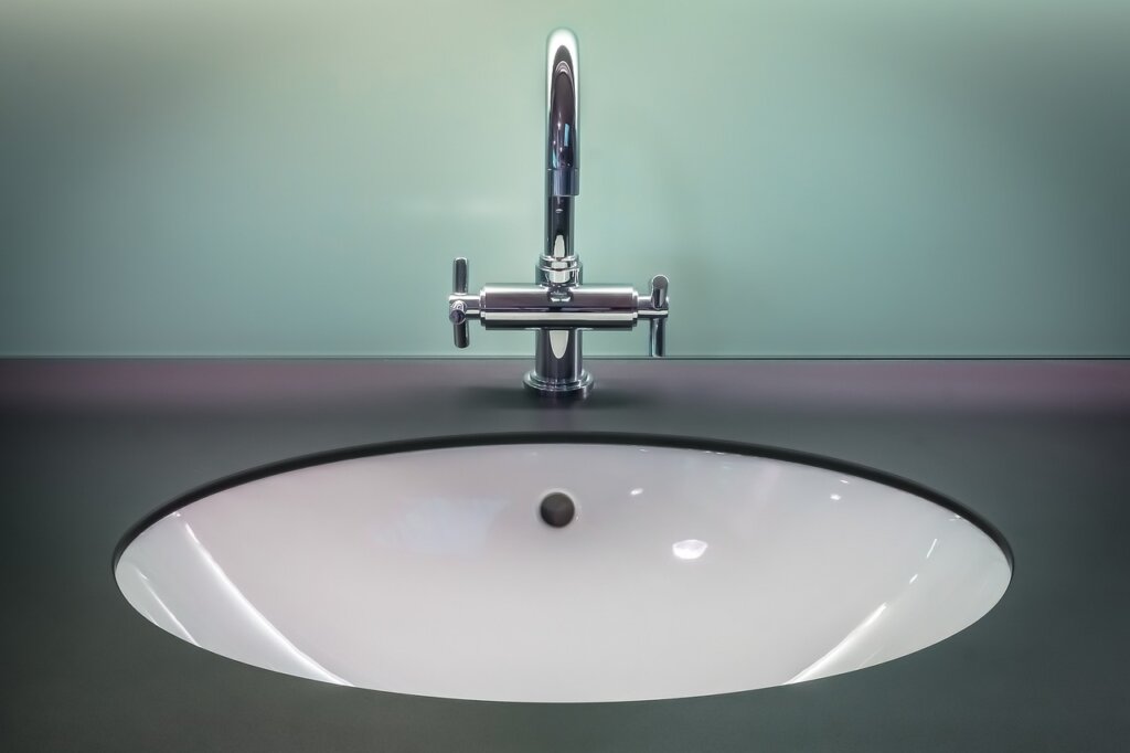 aluminum-free deodorant and clean white shirt laid together on bathroom counter