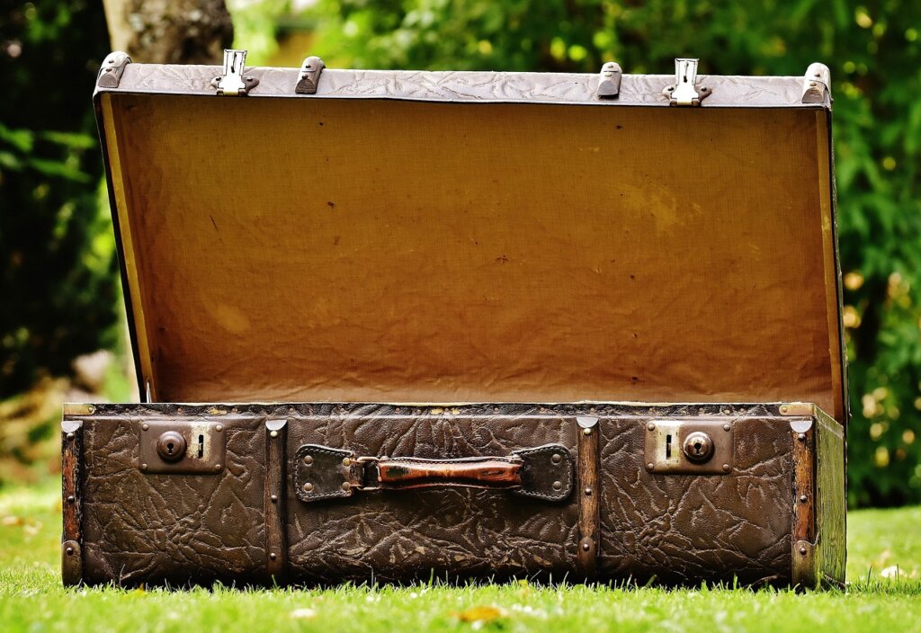 shoes placed at the bottom of suitcase near wheels