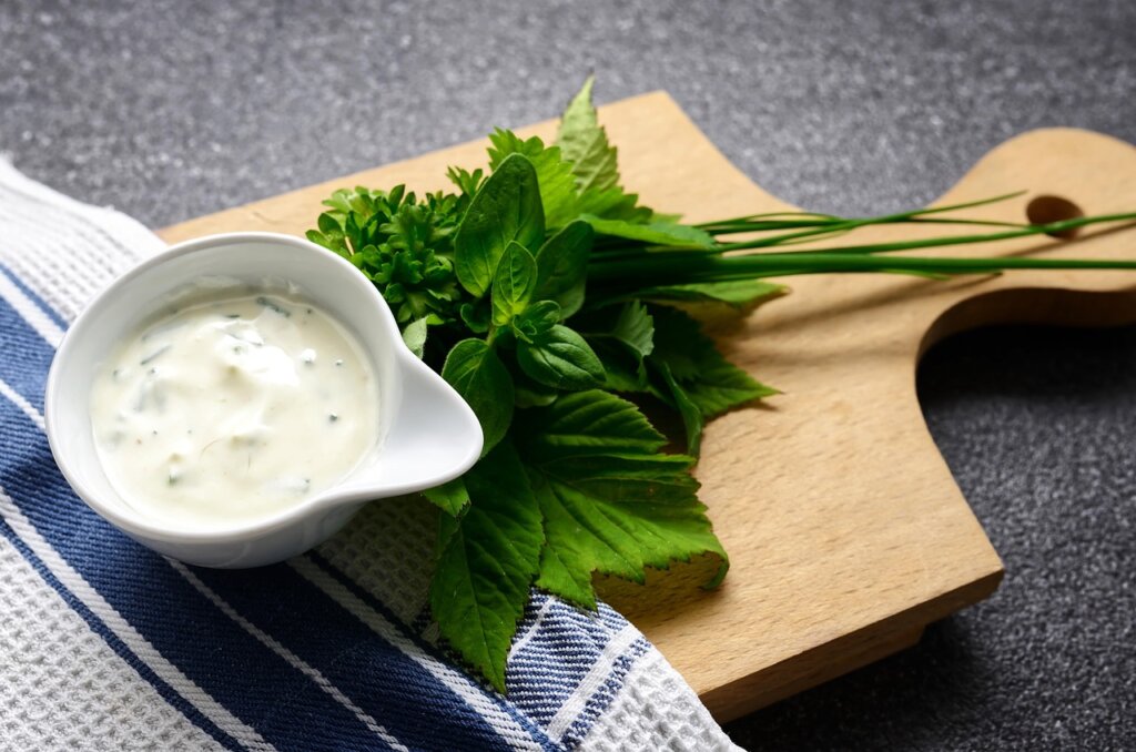 kitchen paper towel wrapping fresh spinach leaves in refrigerator