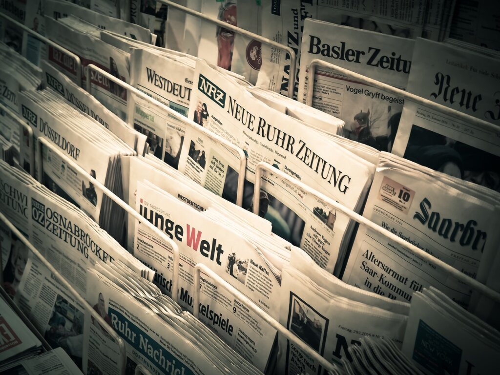 root vegetables wrapped in newspaper inside refrigerator drawer