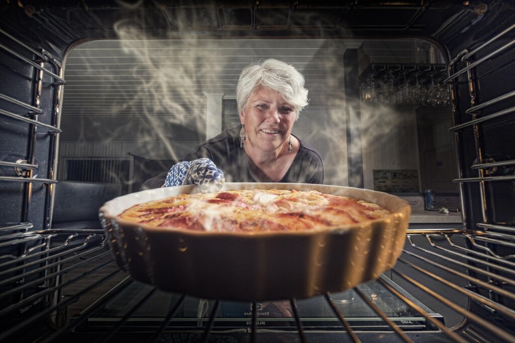 university student cleaning kitchen pot with baking soda smiling