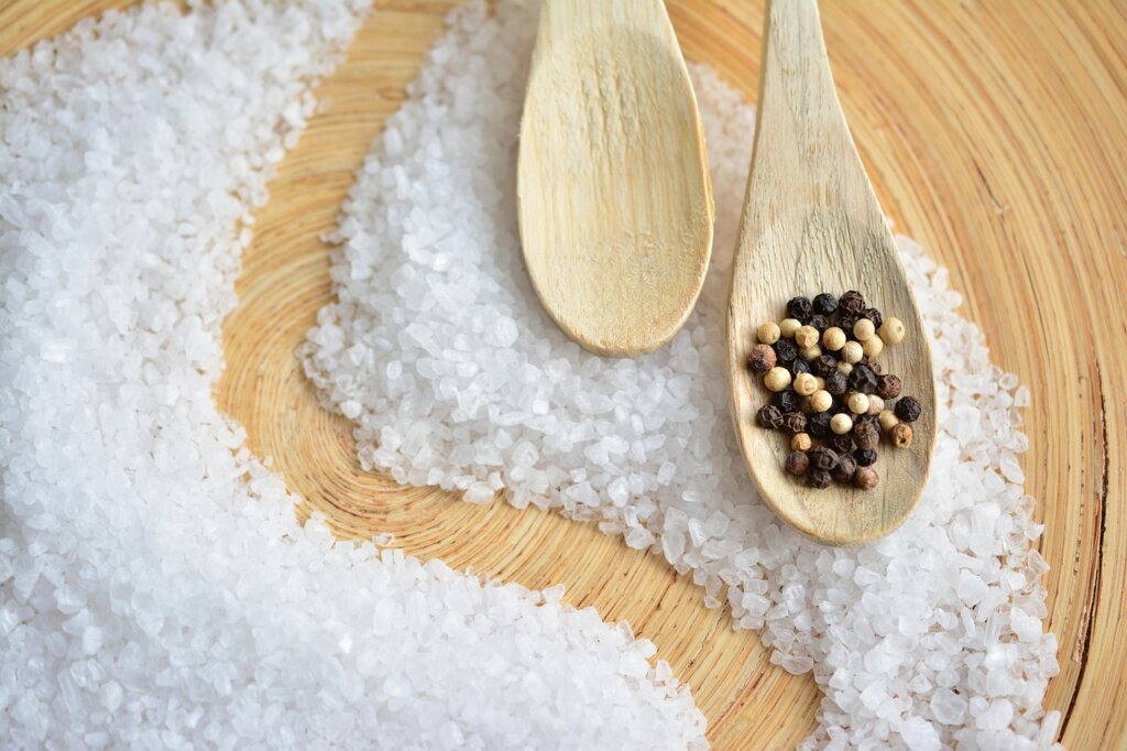 rubber gloves with coarse salt on kitchen counter
