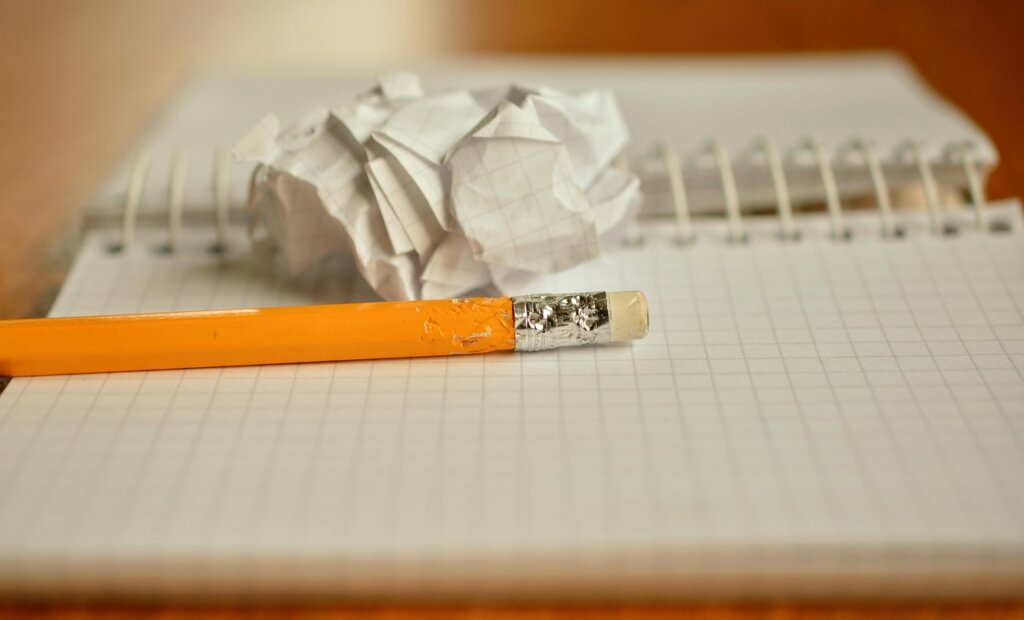 crumpled paper receipts scattered on wooden desk