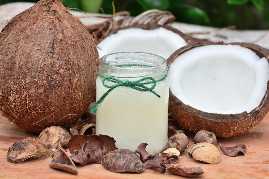 coffee scrub mixture in small bowl with coconut oil and spoon