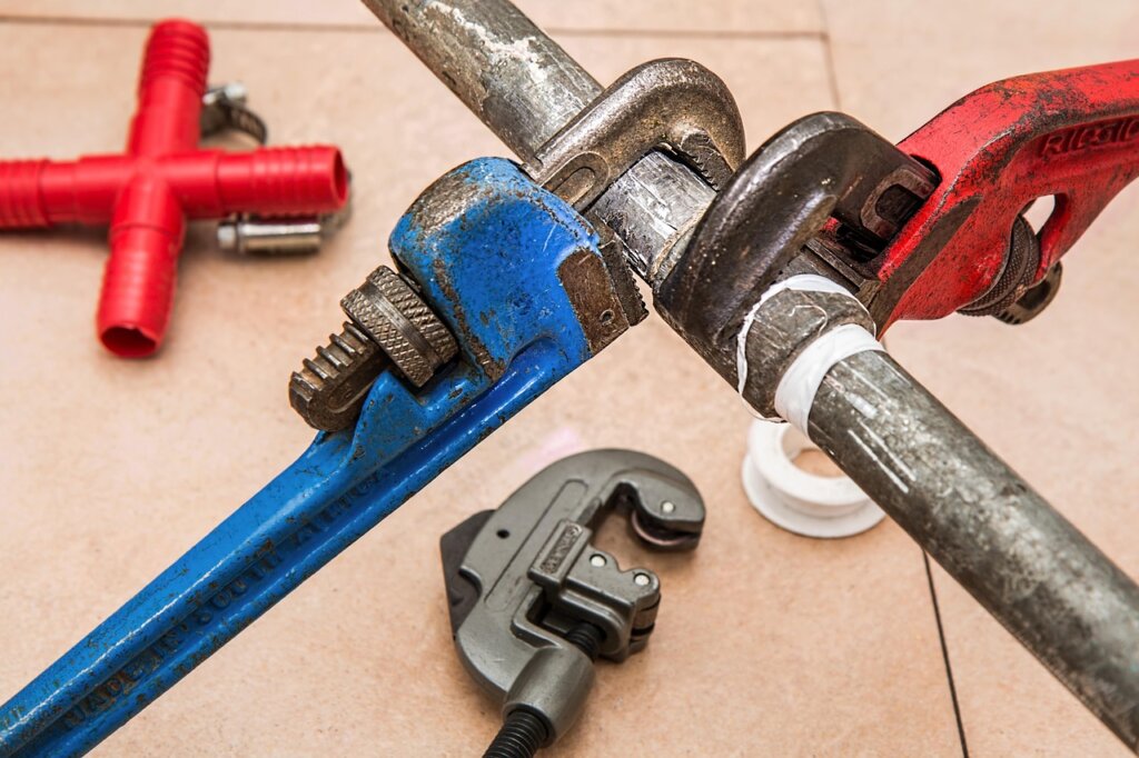 diy plumbing tools layout on white background