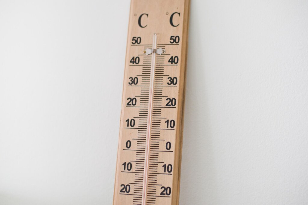 thermometer inside refrigerator showing optimal temperature
