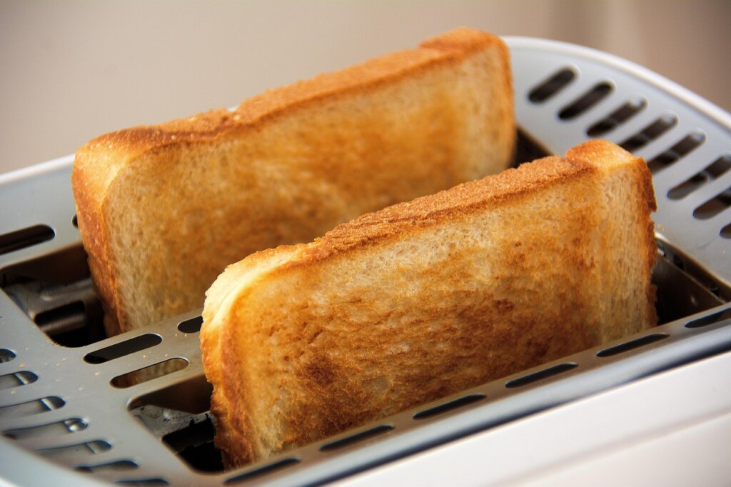 frozen bread slice going into toaster oven